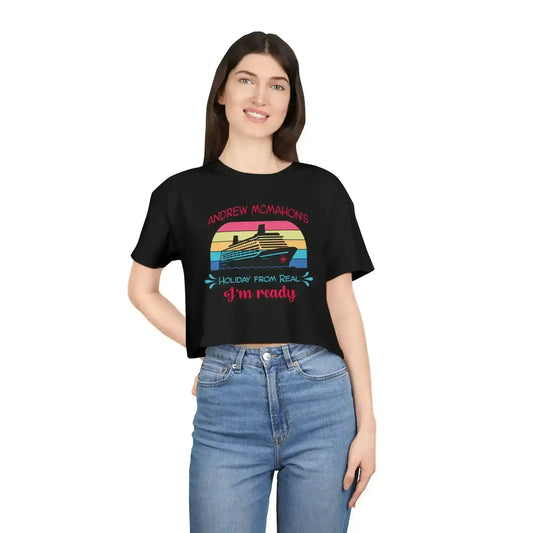 Woman wearing black graphic crop tee with cruise ship and 'Holiday From Real' design from Cady Creations
