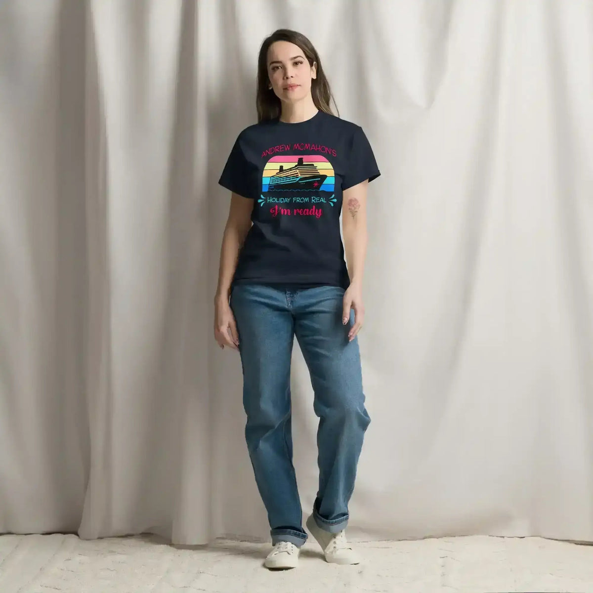 Woman wearing navy unisex graphic tee with cruise ship and sunset design from Cady Creations
