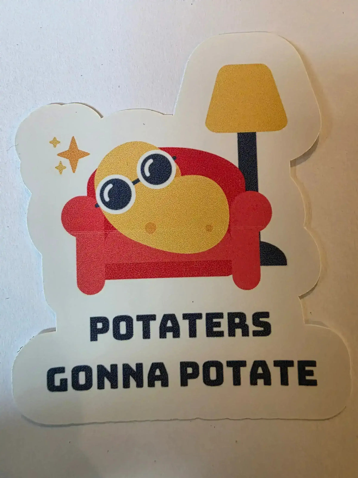 Sticker with cartoon character and text 'POTATERS GONNA POTATE' on a white background