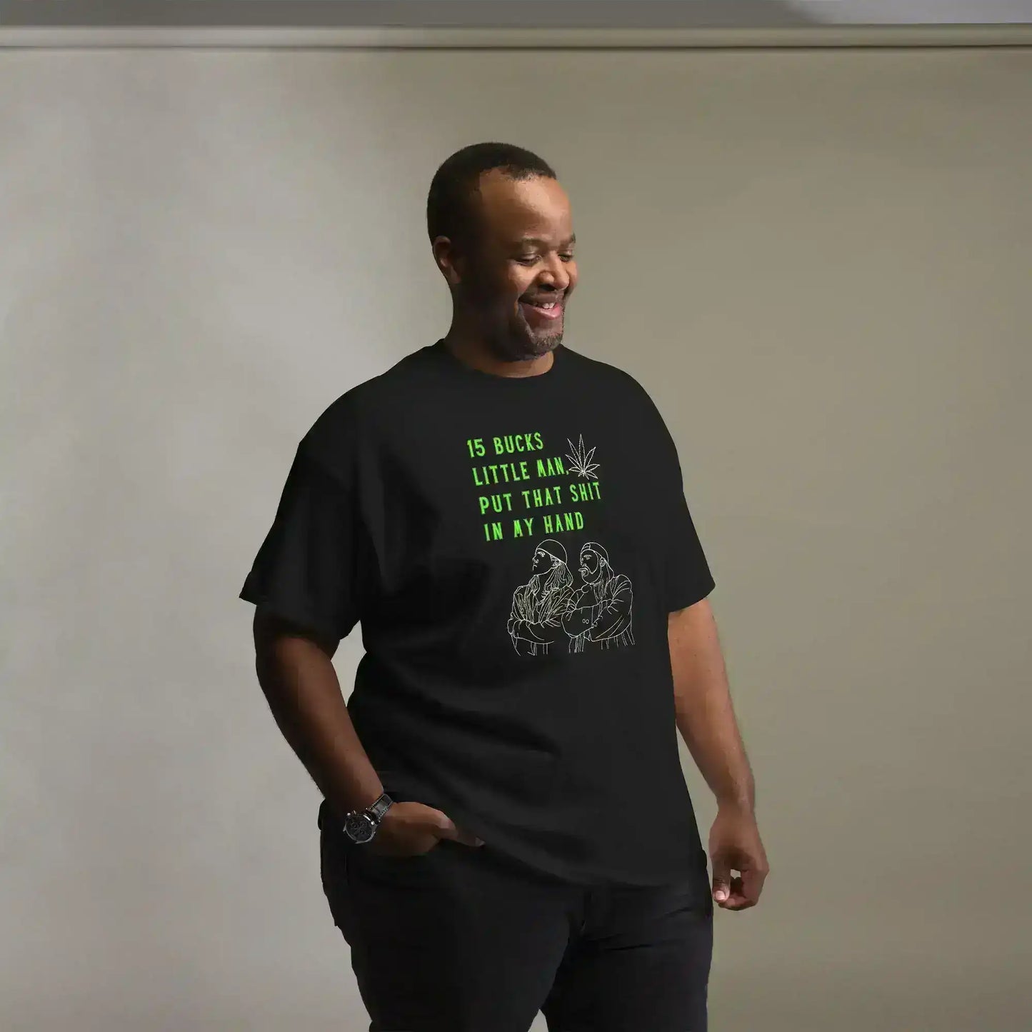 Man wearing black graphic tee with green text and line art, Cady Creations pop culture shirt