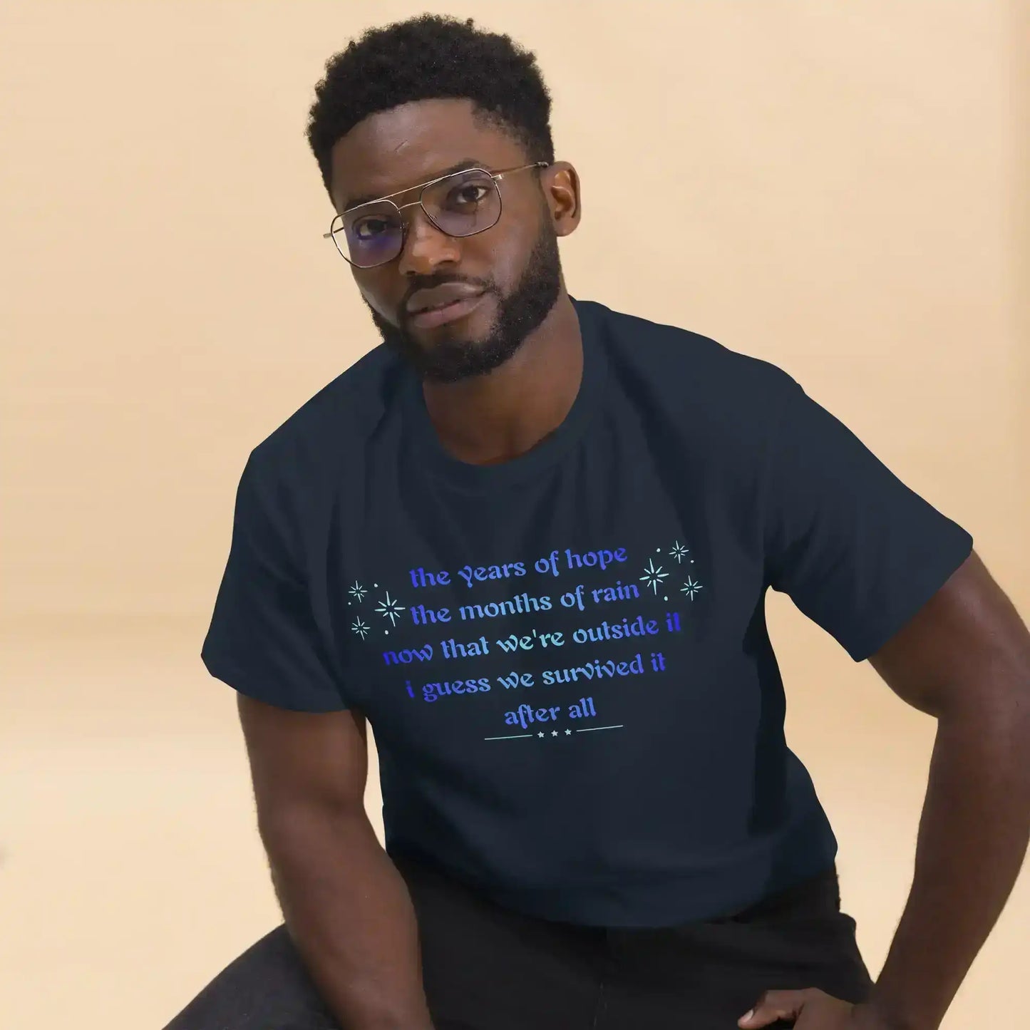 Man wearing navy unisex graphic tee with motivational text, Cady Creations apparel