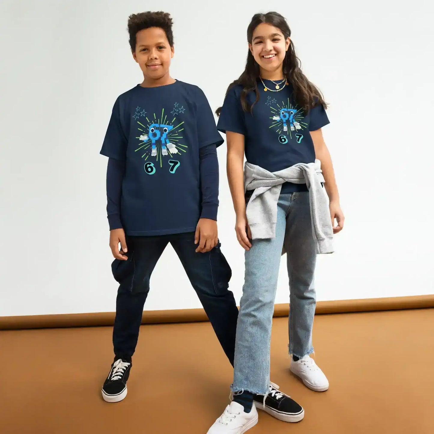 Two kids wearing navy graphic tees with blue character print from Cady Creations collection.