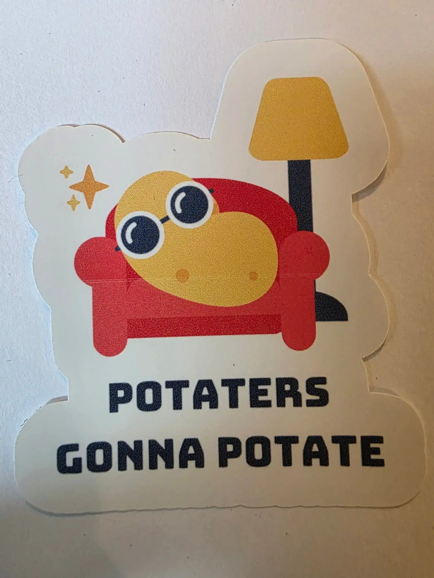 Sticker with cartoon character and text 'POTATERS GONNA POTATE' on a white background