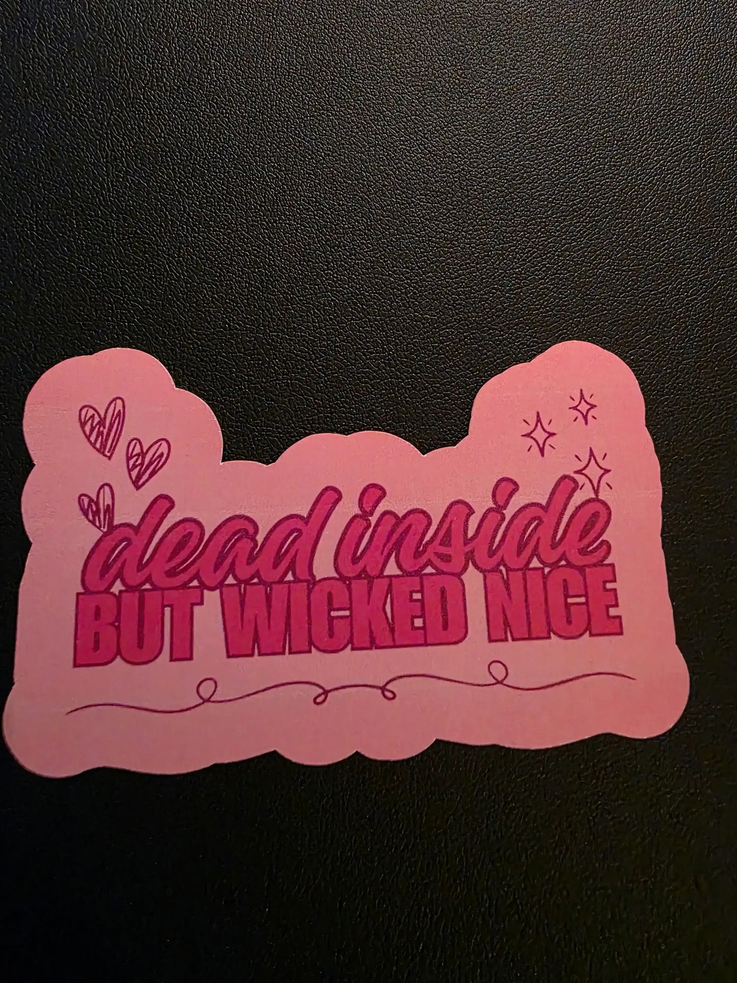 Pink decorative item with text on a black background