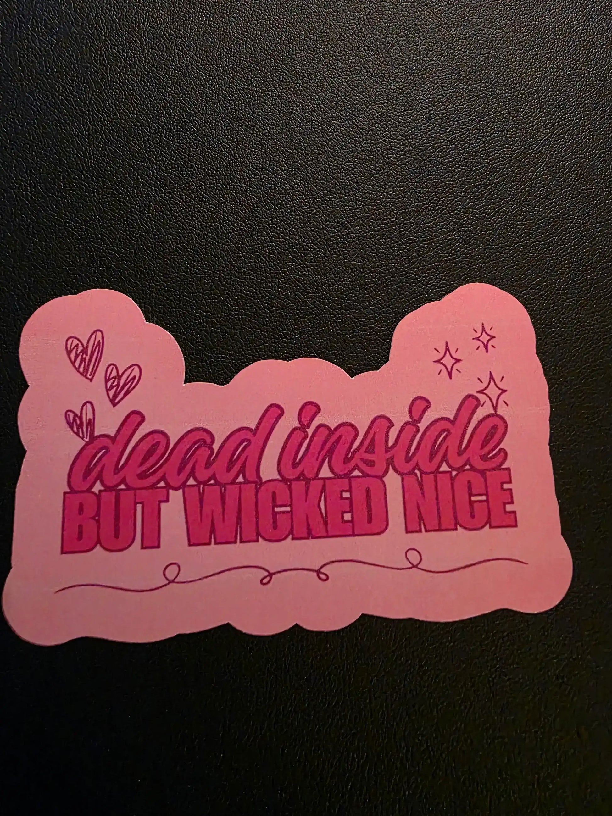 Pink decorative item with text on a black background