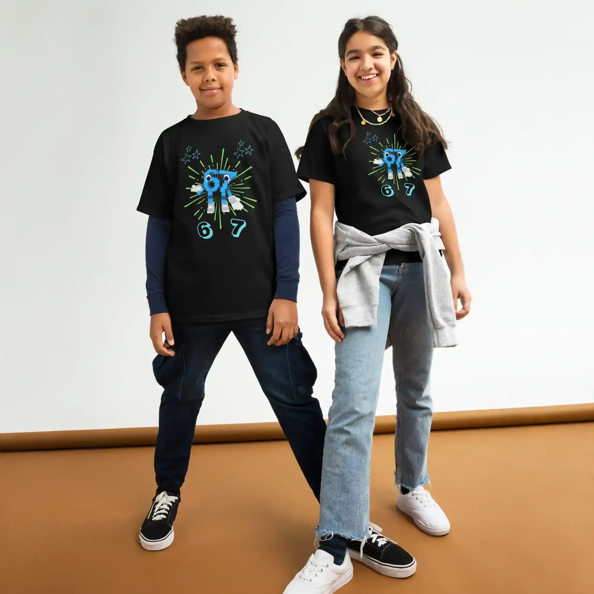 Two kids wear black graphic tees with blue abstract designs, Cady Creations youth apparel