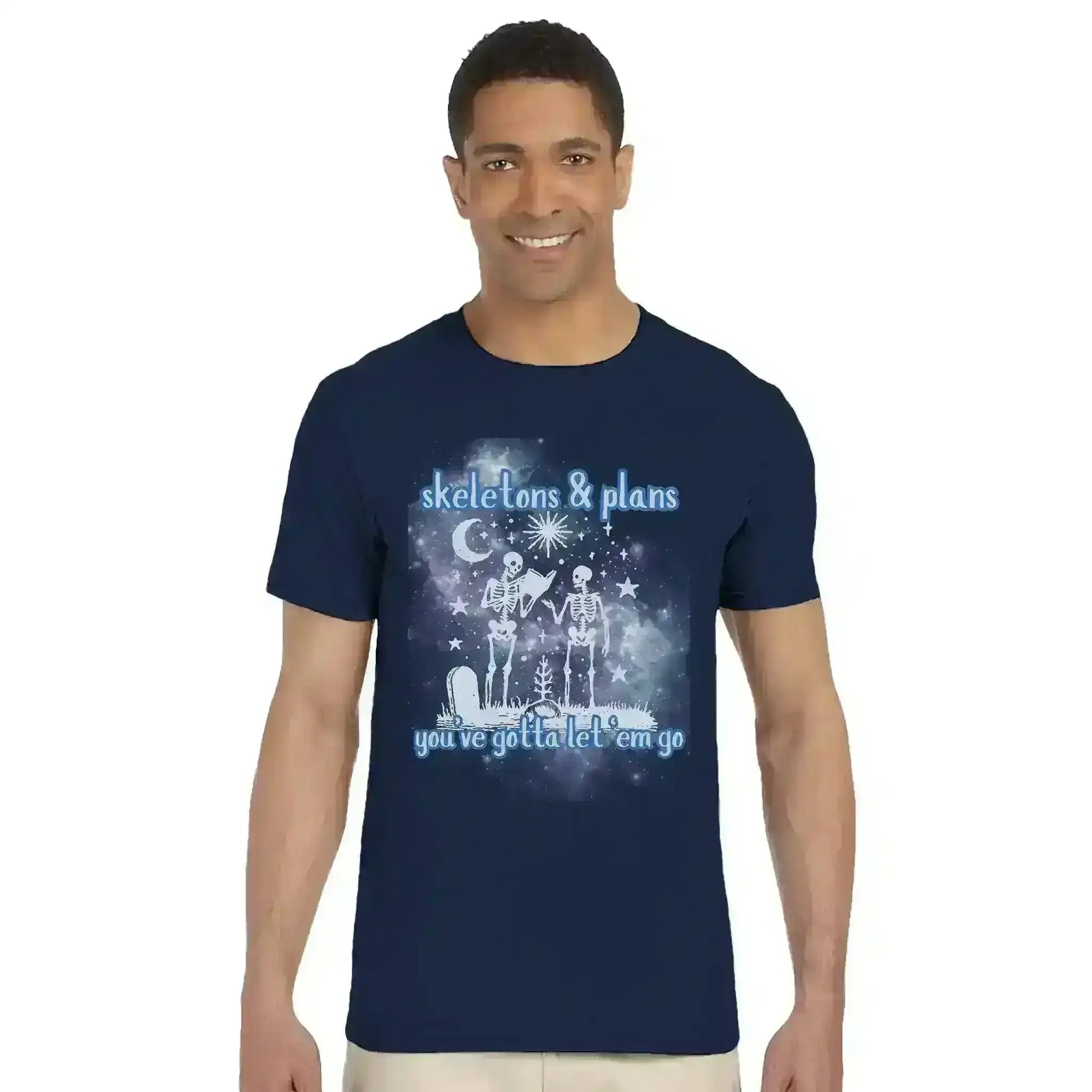 Man wearing navy graphic tee with two skeletons, stars, moon, and 'skeletons & plans' text, Cady Creations