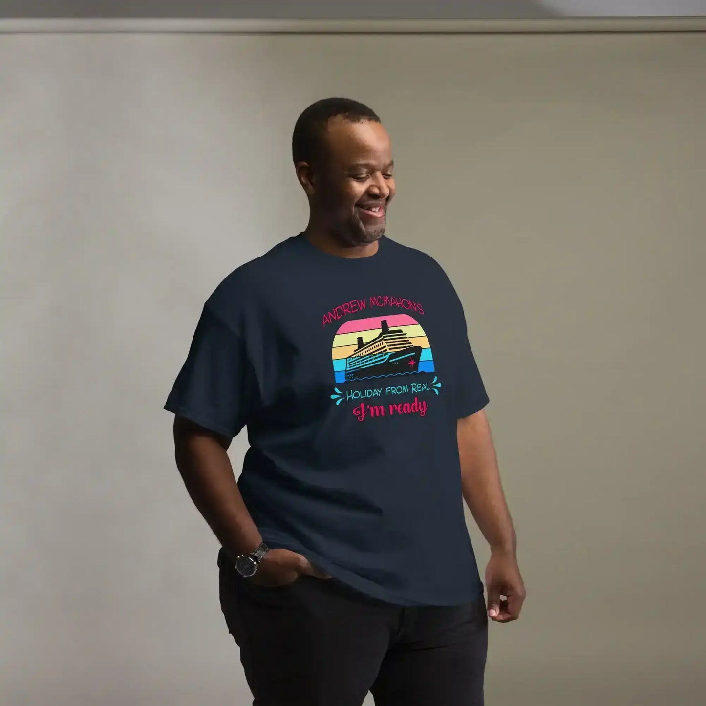 Man wearing a navy graphic tee with a cruise ship and retro sunset design, Cady Creations