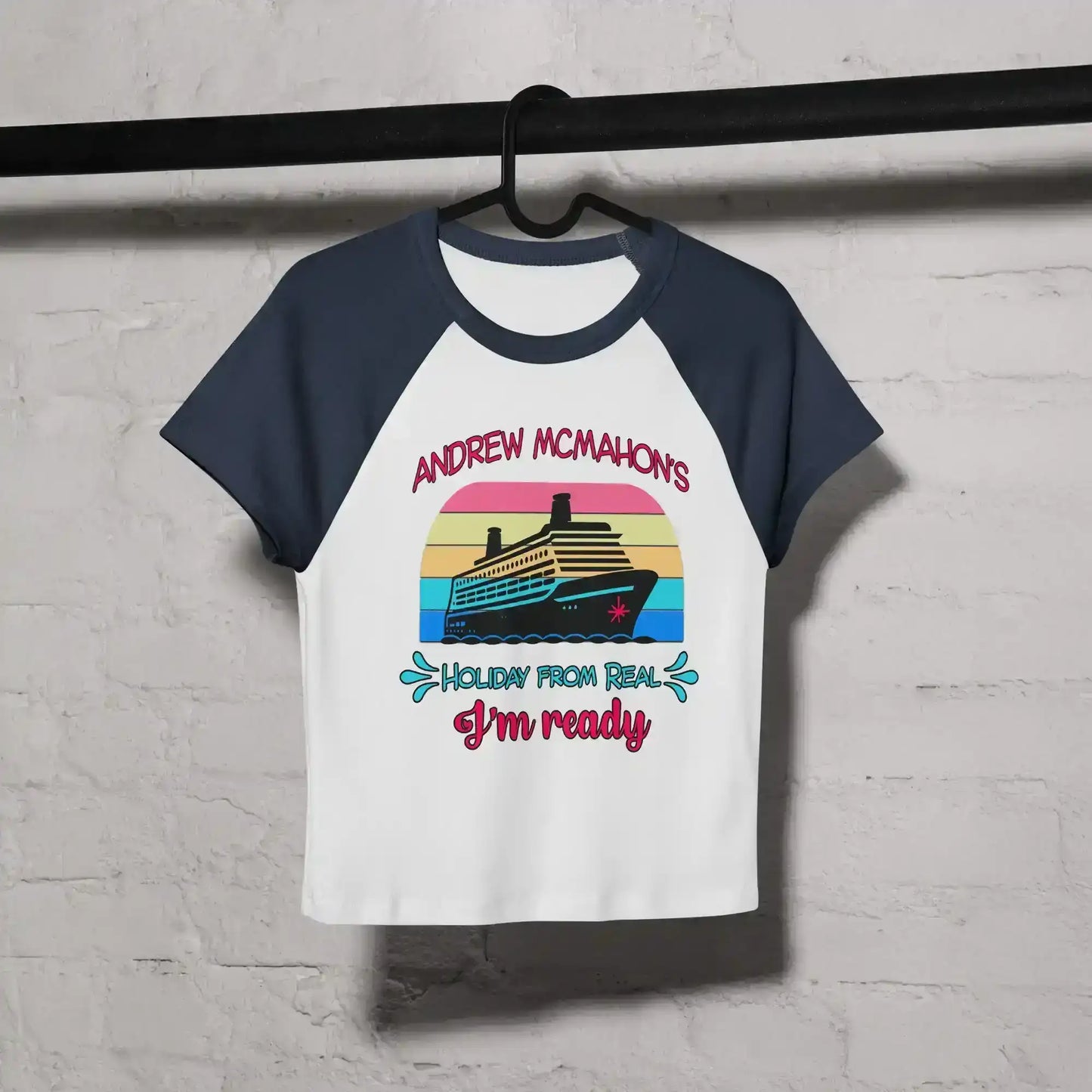 Women's white and navy raglan baby tee with cruise ship graphic and fun text, hanging on hanger