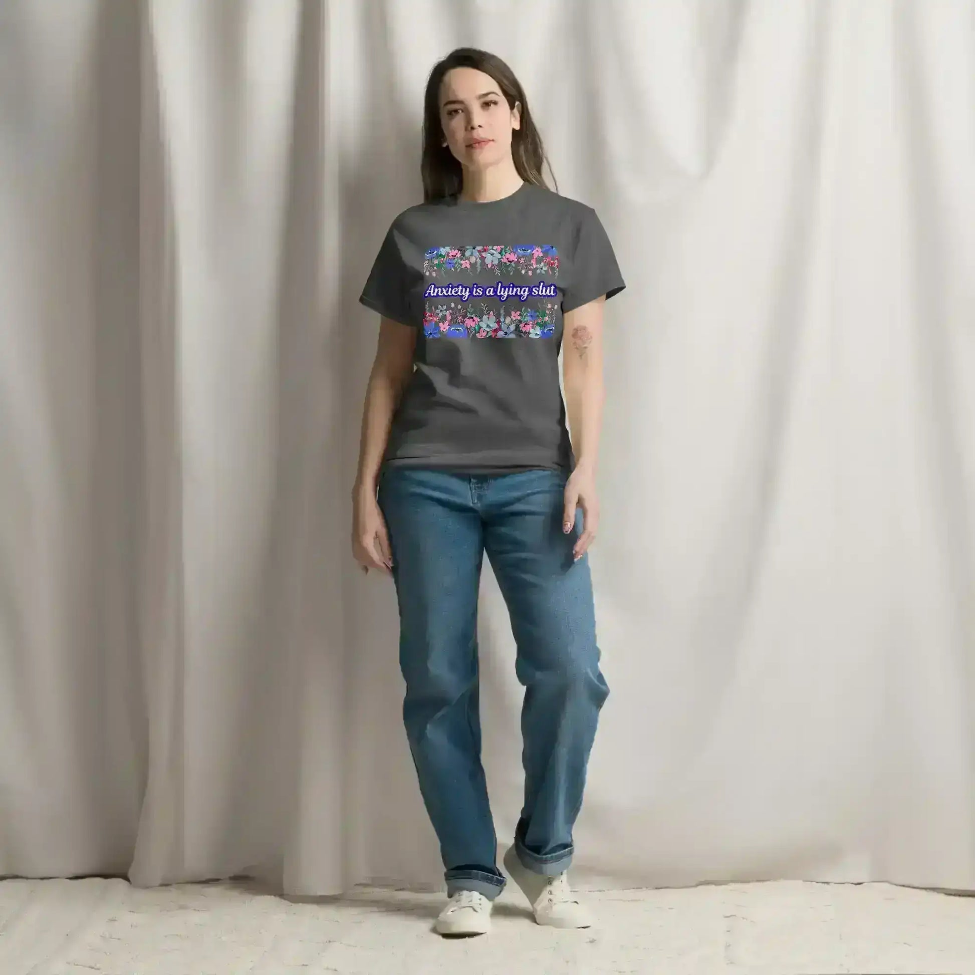 Woman wearing a dark heather graphic tee with bold text and floral pattern by Cady Creations