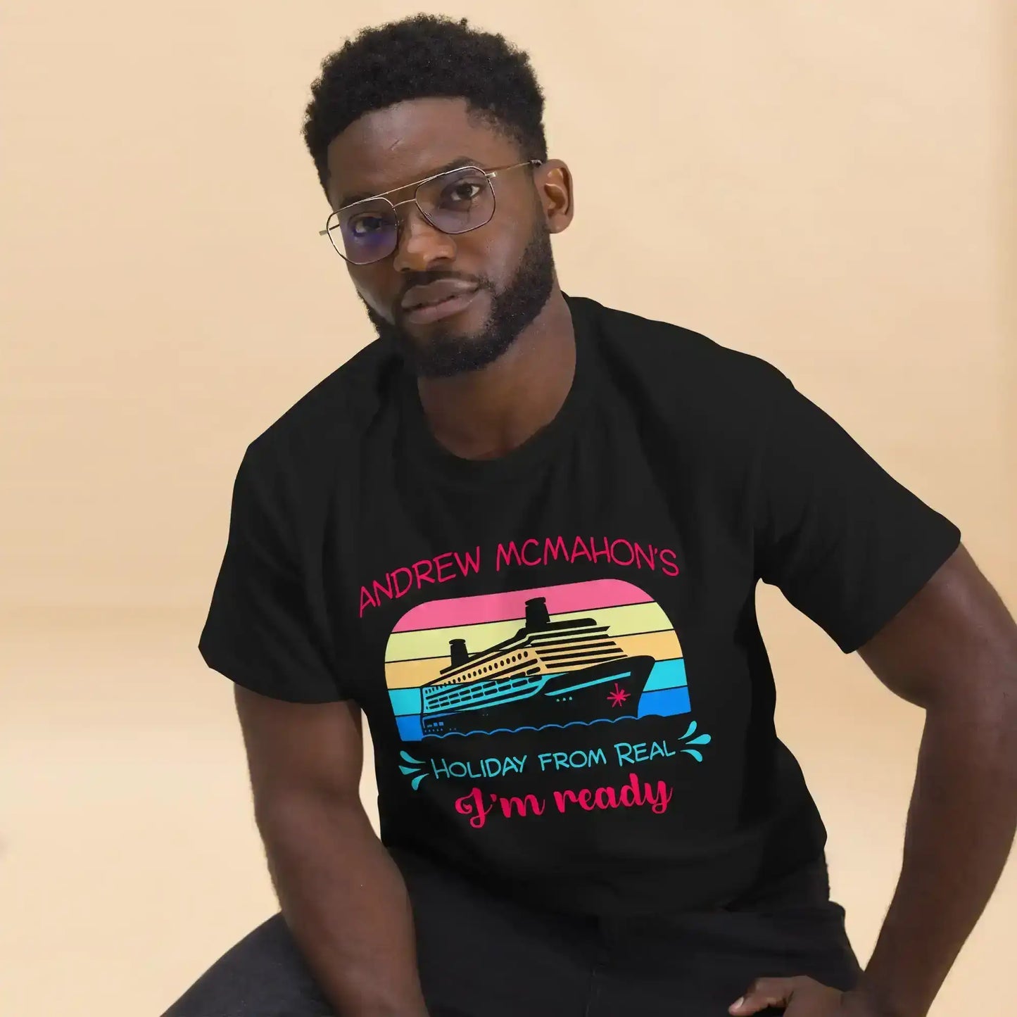 Man wearing a black Cady Creations graphic tee with colorful cruise ship design and text