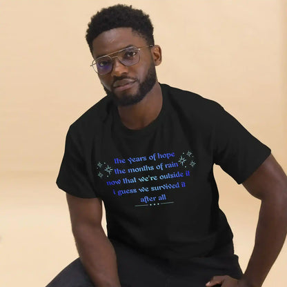 Man wearing black graphic tee with blue text, Cady Creations casual unisex style