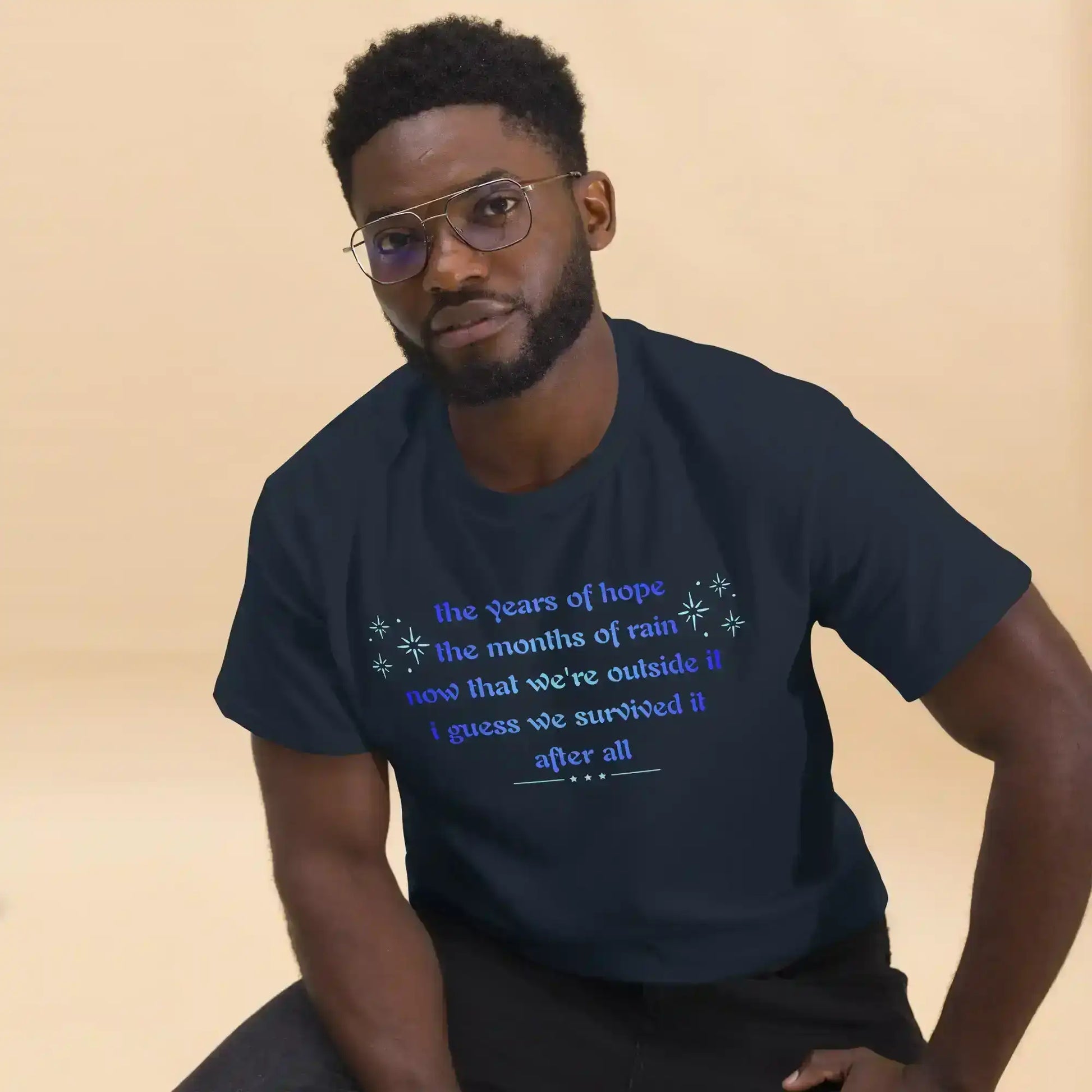 Man wearing navy unisex graphic tee with motivational text, Cady Creations apparel