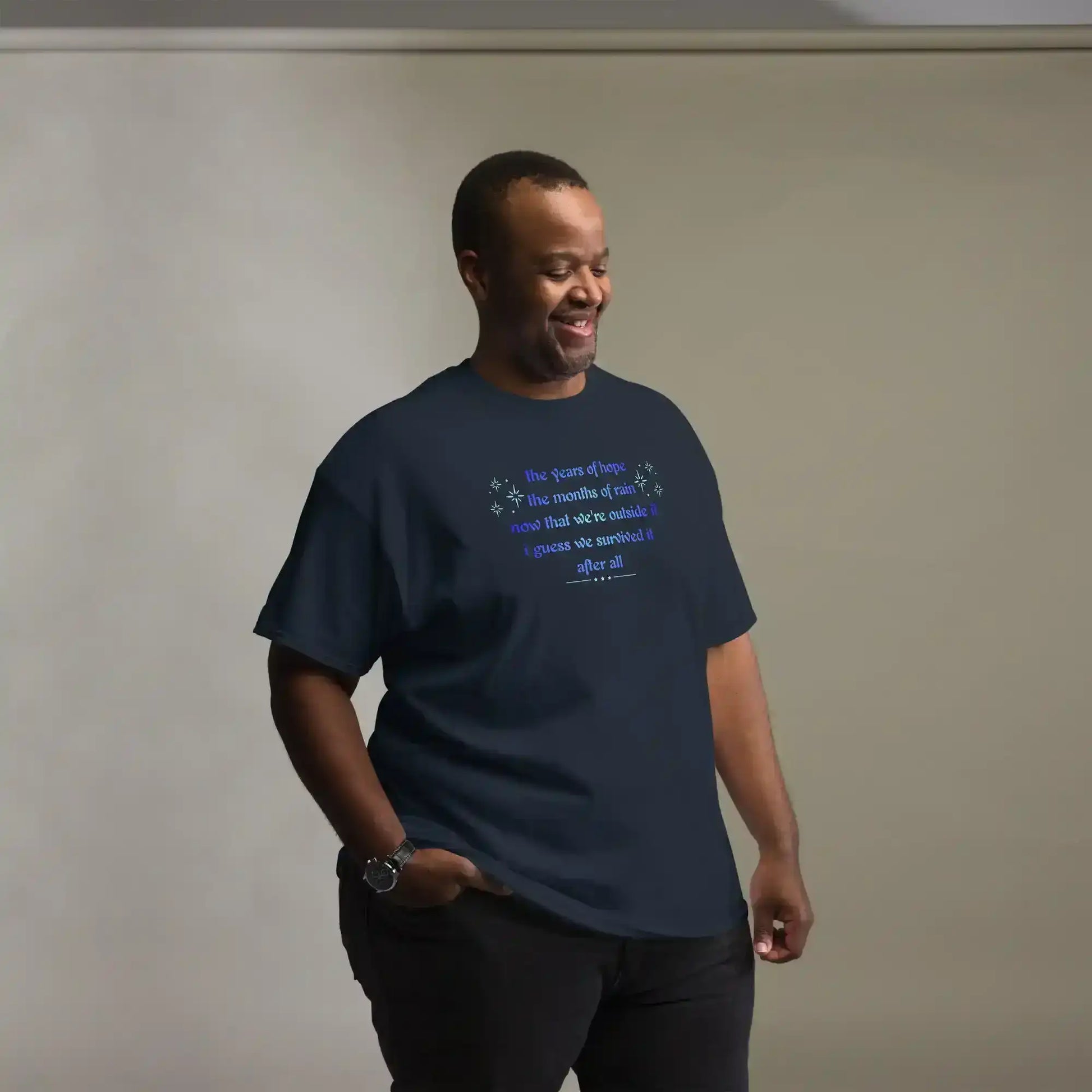 Man wearing Cady Creations unisex navy graphic tee with blue uplifting text design