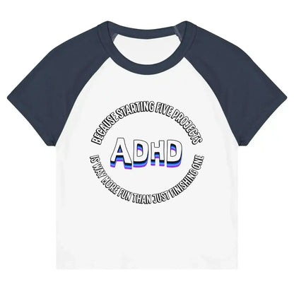 Women's white and navy raglan baby tee with ADHD graphic and playful quote, Cady Creations